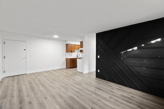 Living room with paneled accent wall at The Cypress
